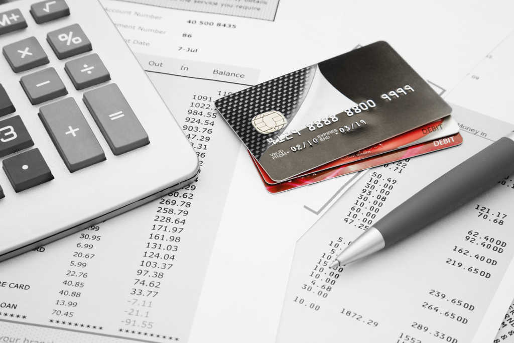 Close up of a credit cards with credit card statements,pen and calculator